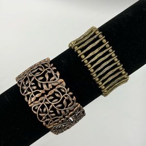 Lot of two stretch bracelets. One is brass tone, and one is copper tone.